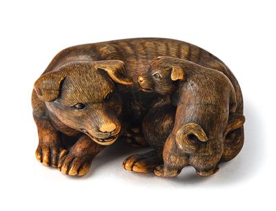 An ivory netsuke of a dog with puppy, Japan, Edo period, 19th century, signed Okatomo, - Asiatics, Works of Art and furniture