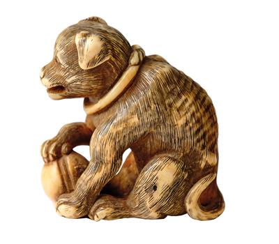 A Netsuke of a Dog with Kemari Ball, Japan, 19th Century, - Works of Art - Part 1