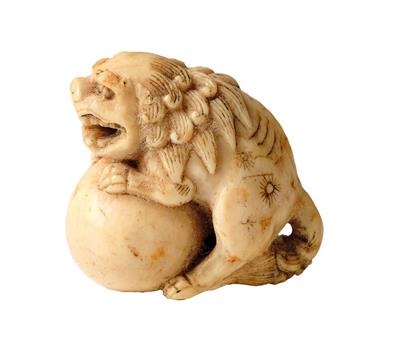 A Netsuke of a Shishi with Ball, Japan, 19th Century, - Works of Art - Part 1