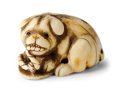 A Netsuke of a Puppy with a Sandal, Japan, 19th Century, Signed Ikko, - Works of Art - Part 1