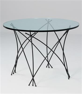 A circular table, designed and manufactured by Gruppe B. R. A. N. D. - Design